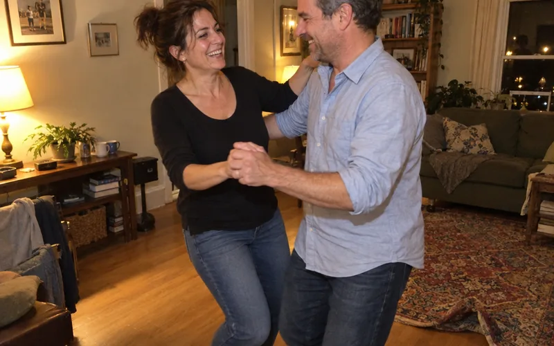 Couple laughing while practicing a dance step in their living room